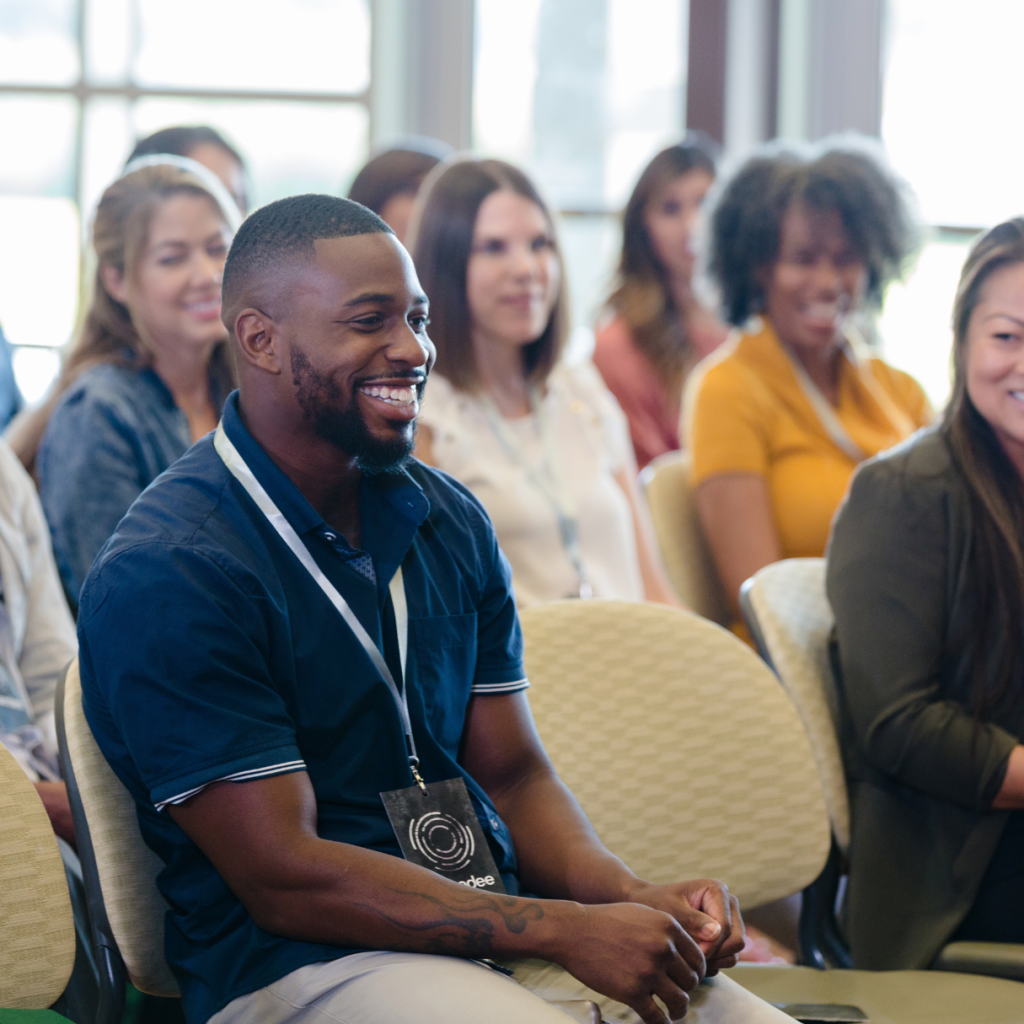 A group of people sitting in an audience