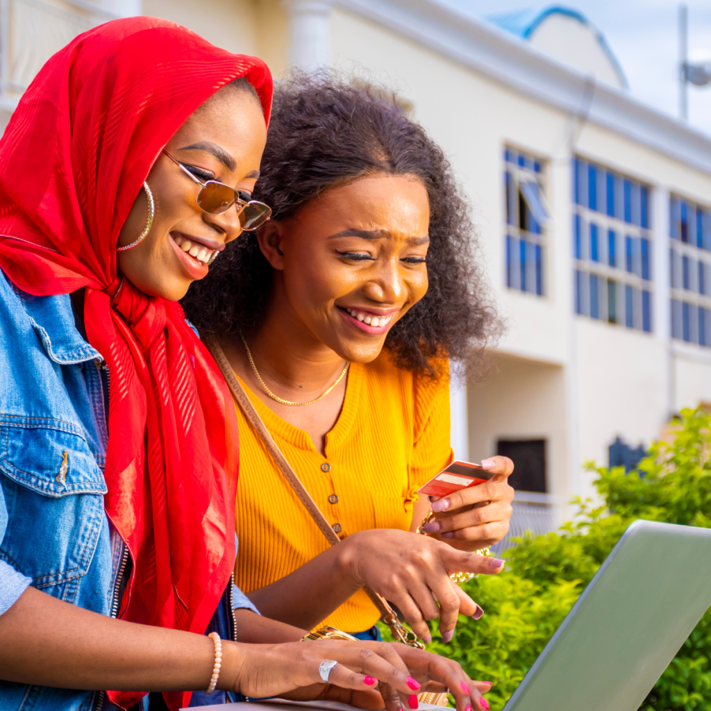 2 women look over a laptop